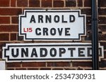 Street sign for Arnold Grove in Liverpool, UK.  The street is famous for being the location where George Harrison - member of The Beatles - was born in 1943, at number 12.