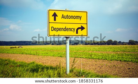 Street Sign the Direction Way to Autonomy versus Dependency