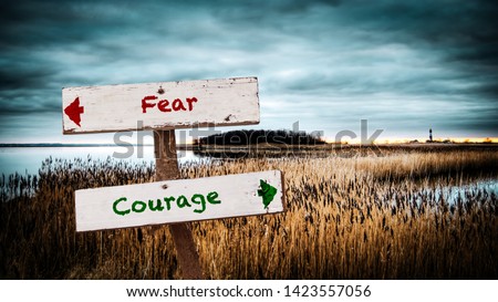 Street Sign the Direction Way to Courage versus Fear