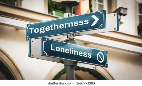 Street Sign the Direction Way to Togetherness versus Loneliness