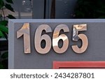 Street sign number 1665 on a building facade