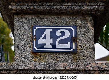 Street Sign Number 42 On A Stone Column