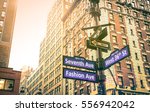 Street sign of Seventh and Fashion Ave with West 36th St at sunset in New York City - Urban concept and road direction in Manhattan - American world famous capital destination on warm vintage filter