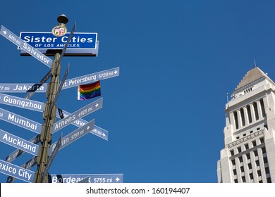 Street Sign With The Sister Cities Of Los Angeles And City Hall Building