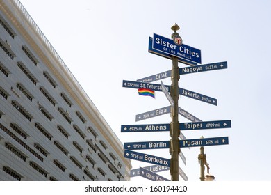 Street Sign With The Sister Cities Of Los Angeles And City Hall Building