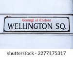 A street sign for Wellington Square in the Chelsea area of London, UK.