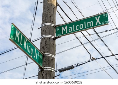 Street signs for Martin Luther King Jr and Malcolm X.  Civil rights leaders.  Lansing Michigan