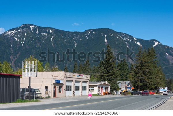 Street of small canadian town on snow mountain\
and blue sky background