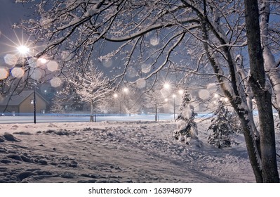 Street In Small Town At Winter Evening. Photo With Light Bokeh