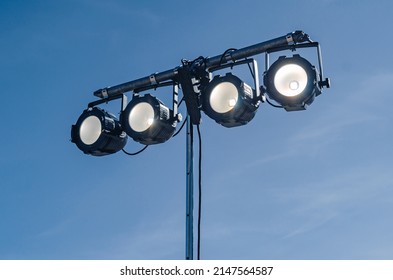 Street spotlight. Four round glowing lamps. Lighting of streets, objects, buildings