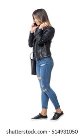 Street Style Fashion Girl Walking While Talking On The Phone And Adjusting Hair. Full Body Length Portrait Isolated Over White Background