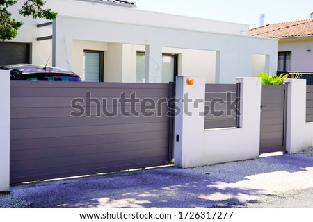 street suburb home grey brown dark metal aluminum house gate slats garden access door