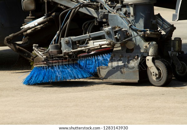 A street\
sweeper machine cleaning the\
street.