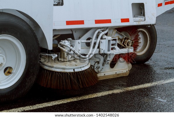 A street sweeper machine cleaning in the road\
cleaning asphalt