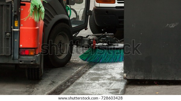A street\
sweeper machine cleaning the\
streets.