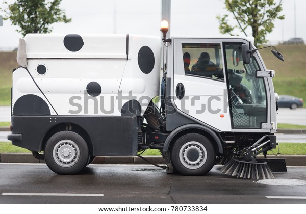 A street\
sweeper machine cleaning the\
streets
