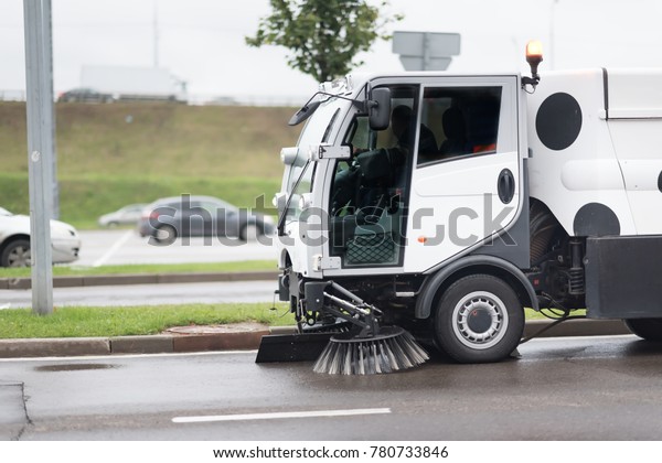 A street\
sweeper machine cleaning the\
streets