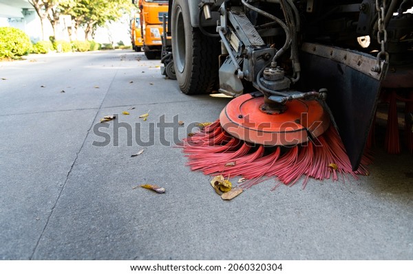 Street sweepers are\
cleaning city street.