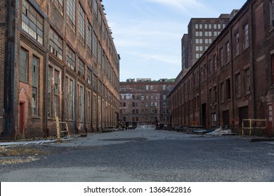 Street Through A Complex Of Derelict Industrial Buildings, Daylight, Horizontal Aspect