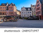 Street with timber framing houses and tables of restaurant in Rouen, Normandy, France. Architecture and landmarks of Rouen. Cozy cityscape of Rouen