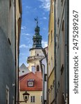 Street with tower of Church of the Holy Trinity, Regensburg, Germany