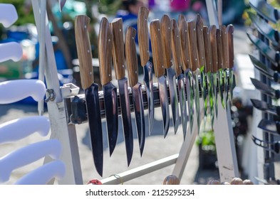 Street Trade. Traditional Fair. The Counter With Handmade Knives. Various Knives With Wooden Handles In A Row.  Daytime. No People. Selective Focus.