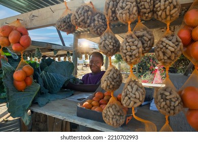 Street Vendor In Africa Selling Peanuts Oranges And Cabbage