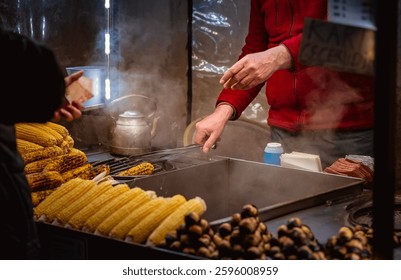 Street vendor grilling corn and roasting chestnuts in Istanbul, with steam rising, capturing the warmth and tradition of street food during Ramadan and Eid. - Powered by Shutterstock - Get 15% off with code: PIKWIZARD15