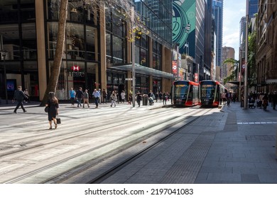 Street View Of Light Tram In Central Business District Of Sydney Australia On 30 August 2022. Two Light Rails On Tracks On Road. People And Buildings Can Be Seen In The Image.