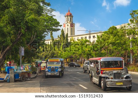street view of manila with jeepney and clock tower