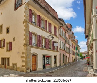 Street view of old buildings in a historic city with built medieval architecture and a cloudy blue sky in Annecy, France. Beautiful landscape of an empty small urban town with homes or houses