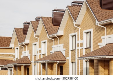 Street view on a row of a new modern residential house complex - Shutterstock ID 502758400