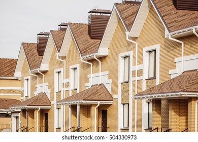 Street view on a row of a new modern residential house complex - Shutterstock ID 504330973