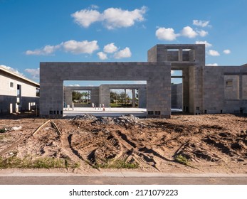 Street View Of Residential Construction Site With Sandy Rutted Lot In Front Of Concrete Shell Of Single-family House On A Sunny Afternoon In Southwest Florida