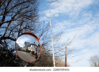 A street view in a road sign mirror  with a lovely spring day - Shutterstock ID 2280709451