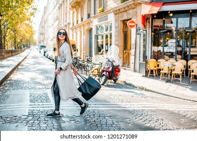 Street View With Traditional French Cafe And Woman Walking During The Morning In Paris