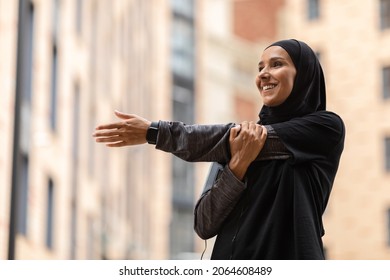 Street Workout. Athletic Young Muslim Female In Modest Sportswear Training Outdoors, Sporty Islamic Woman In Hijab Stretching Arm Muscles, Getting Ready For Outside Workout, Closeup Shot