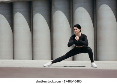 Street Workout Of A Beautiful Girl Lunging For Stretching Inner Thigh Muscles.