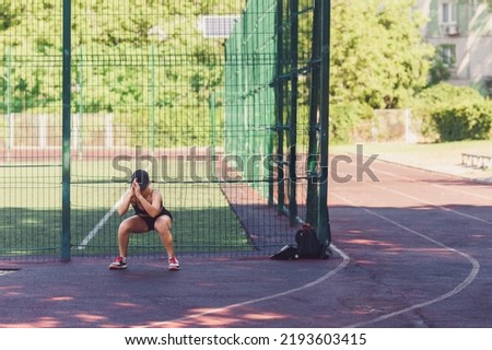 Similar – Young woman stretching legs before training outdoors