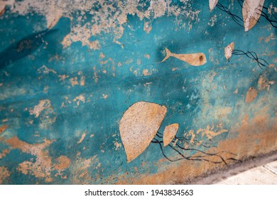 Streetart on rusty boat, jellyfish on teal background