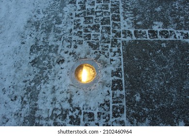 The Streetlight Illumination Lamp On The Paving Stones In A Winter Evening Park 