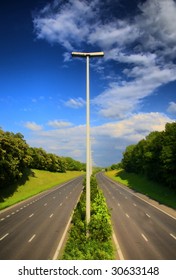 Streetlight On A Highway With A Blue Sky, E40, Belgium