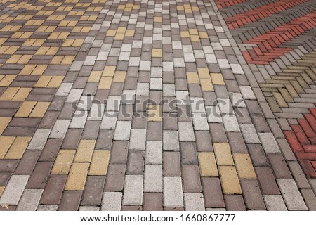Streetlights and texture of different colored patterned paving slabs on the ground of street, representative patio tiles alley, street exterior design. Sidewalk pavement pattern.