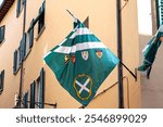 Streets of Arezzo come alive with vibrant flags displaying local symbols, reflecting the town