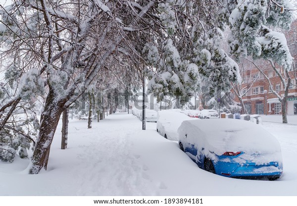 Streets and buildings covered\
in snow by day due to snowstorm Filomena falling in Madrid\
Spain\
