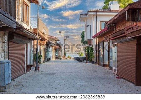 The streets of the city centre, the bazaar and the port area in Side, Antalya. Street view. Sunset cloudy sky. Cafe, restaurant, shop and houses. no people. Selective Focus