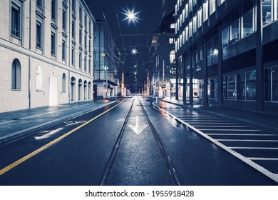 Streets of Geneva downtown by rainy night : Tram track and leading lines at night from the middle of the road. - Powered by Shutterstock