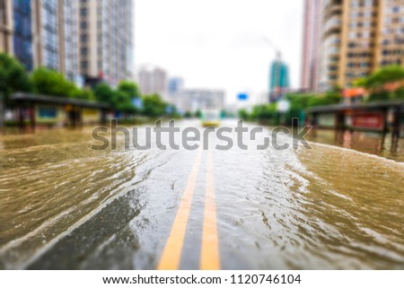 Streets inundated by heavy rain in the city. The background of urban construction and management.