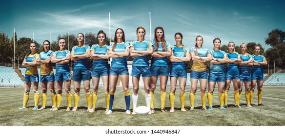 Strength and beauty. Female team of rugby players standing crossing hand at the stadium in sunny day. Fit caucasian models as a professional sportswoman. Sport competition, motion, movement, fight. - Powered by Shutterstock