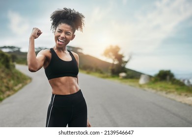 Strength Comes From Within. Cropped Shot Of An Attractive Young Sportswoman Flexing Her Bicep Outside.